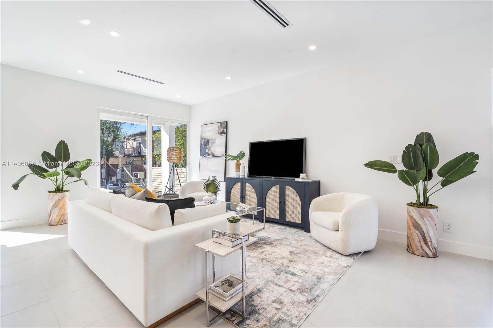 2290 Southeast 6th Street Pompano Beach, FL 33062 - Photo 9 of 22 a living room with furniture a flat screen tv and a potted plant