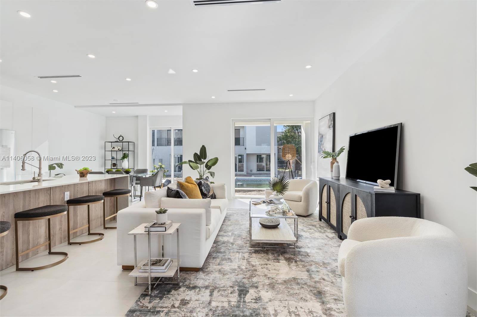 2290 Southeast 6th Street Pompano Beach, FL 33062 - Photo 10 of 22 a living room with furniture and a flat screen tv