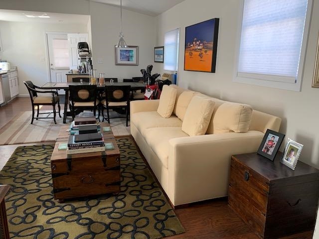a living room with furniture and wooden floor