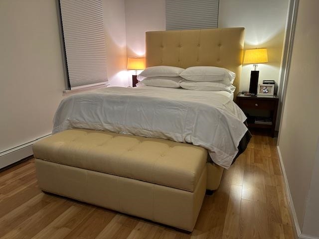 136 Sampson Place Long Branch, NJ 07740 - Photo 4 of 18 a bedroom with a bed and wooden floor