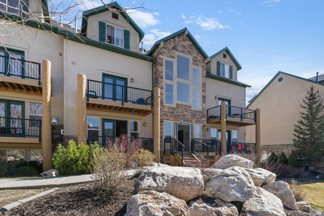 3598 North Huntsman Path, Unit 502 Eden, UT 84310 - Photo 39 of 43 Back of house with stone siding and a balcony