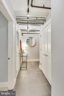 a view of a hallway with wooden shelves