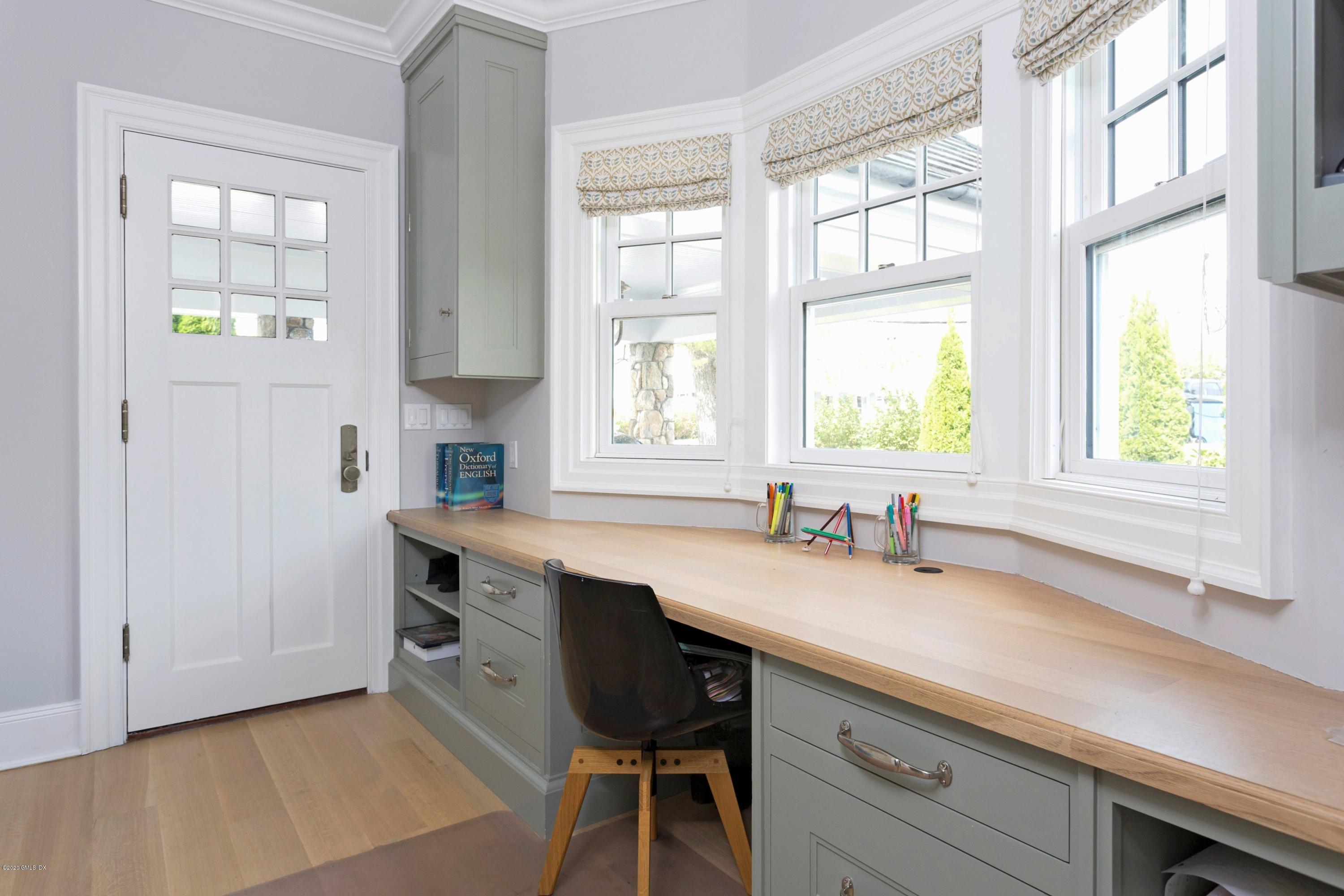 186 Shore Road Old Greenwich, CT 06870 - Photo 14 of 37 a kitchen with a sink a window and cabinets