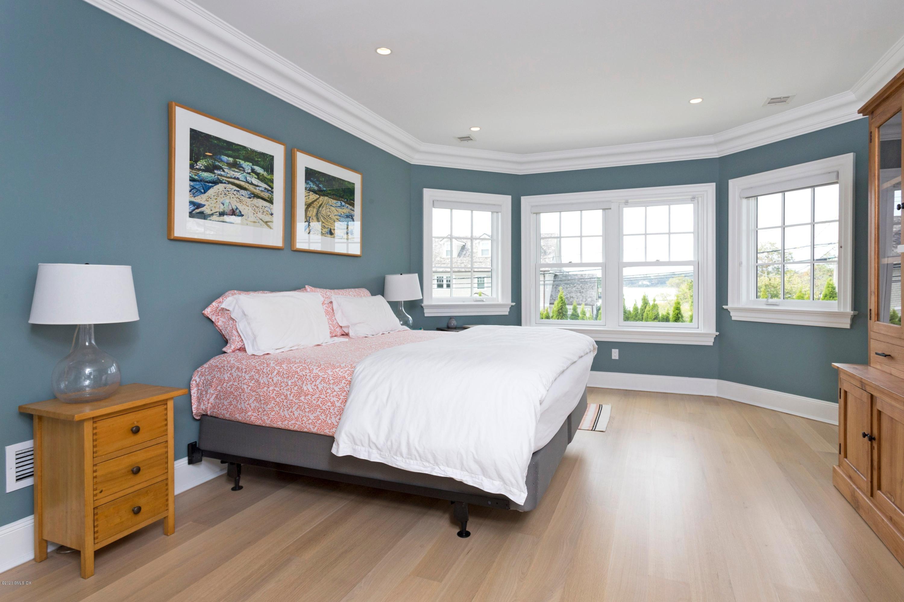 186 Shore Road Old Greenwich, CT 06870 - Photo 24 of 37 a bedroom with a bed and a window