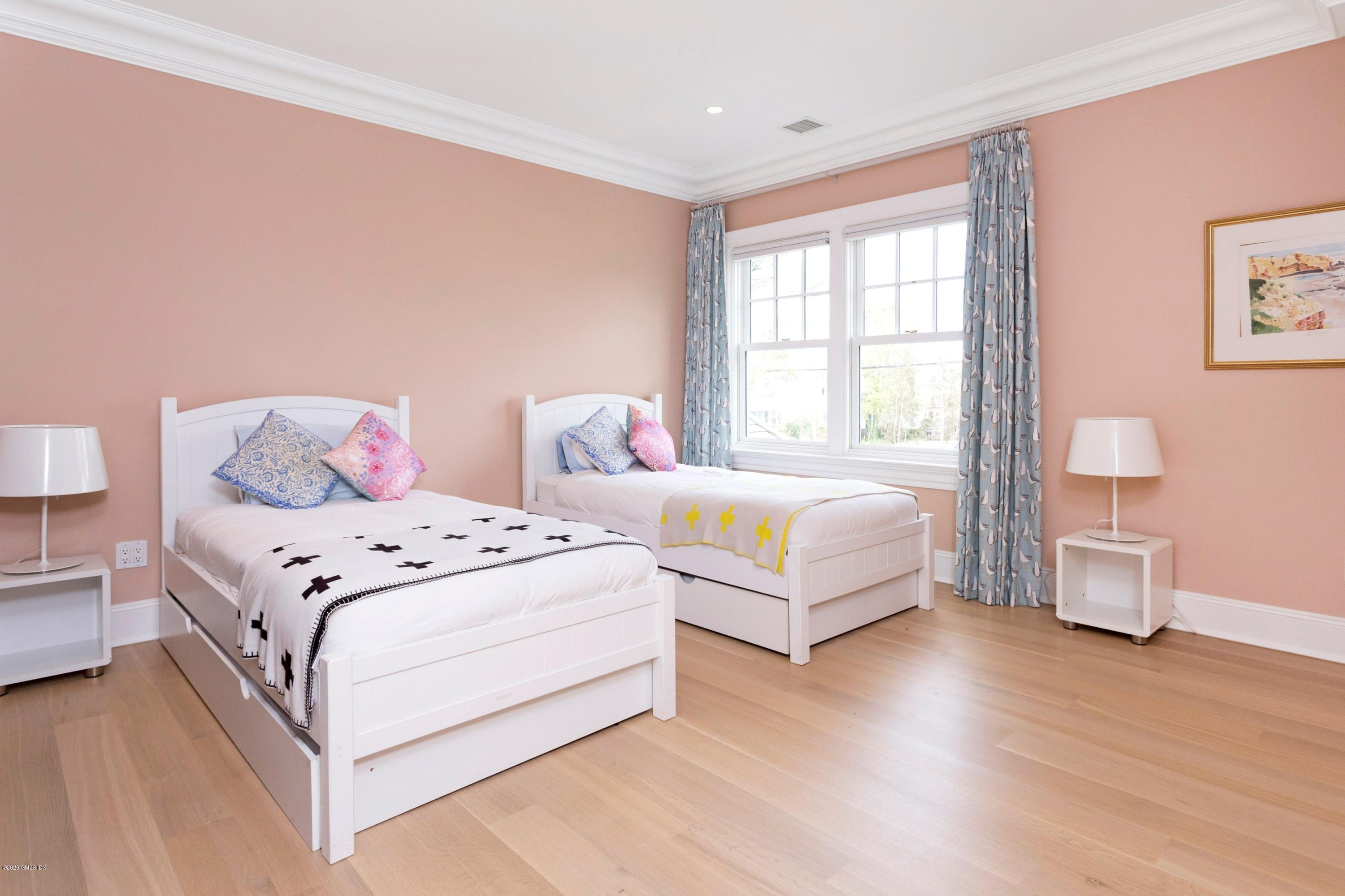 186 Shore Road Old Greenwich, CT 06870 - Photo 26 of 37 a bedroom with a bed and wooden floor