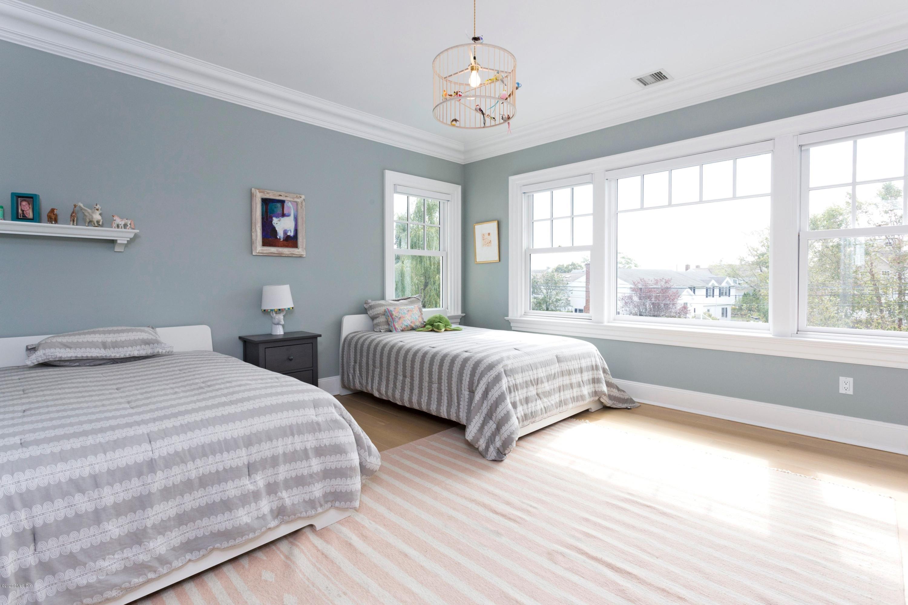 186 Shore Road Old Greenwich, CT 06870 - Photo 27 of 37 a bedroom with bed and a window