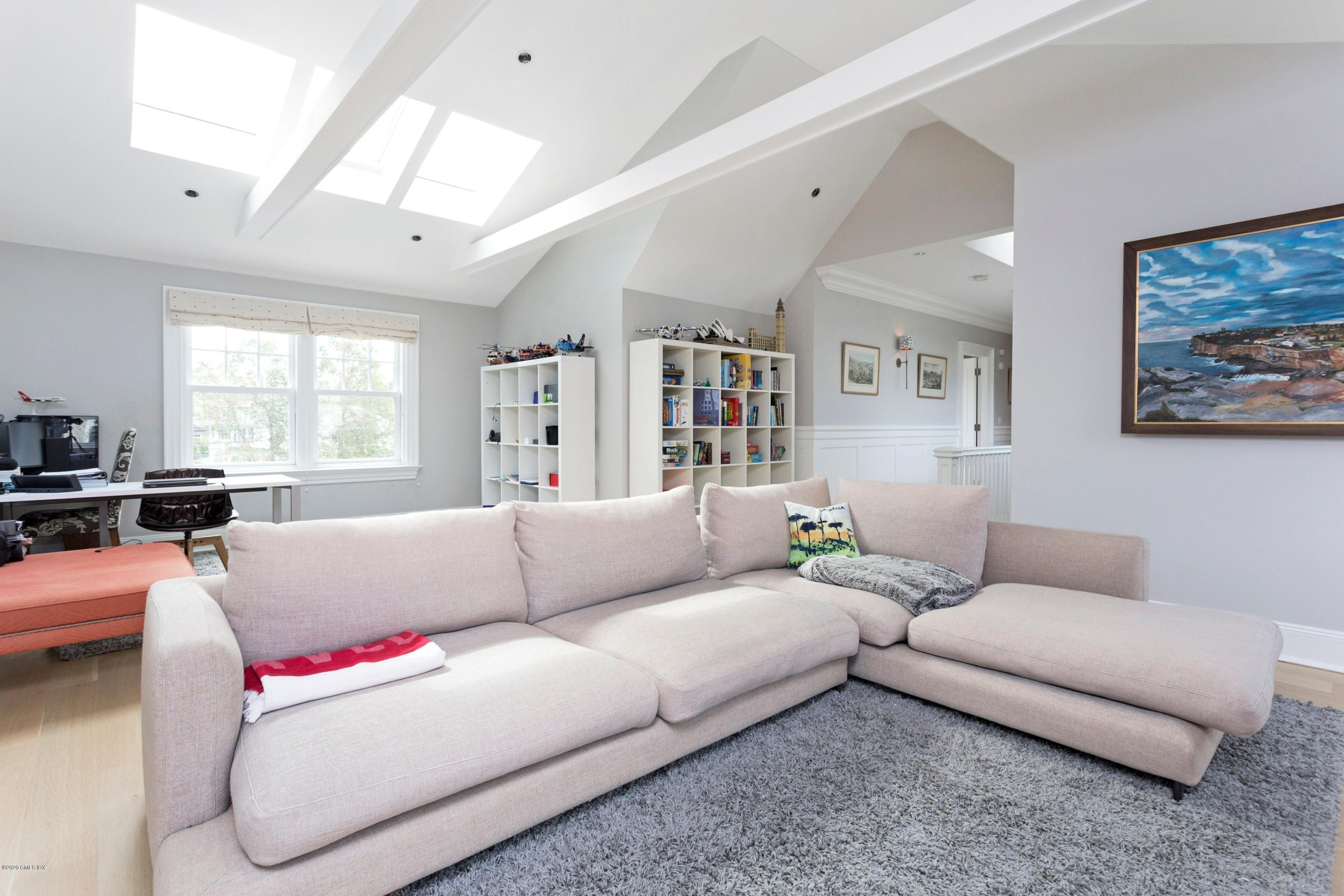 186 Shore Road Old Greenwich, CT 06870 - Photo 28 of 37 a living room with furniture and a large window