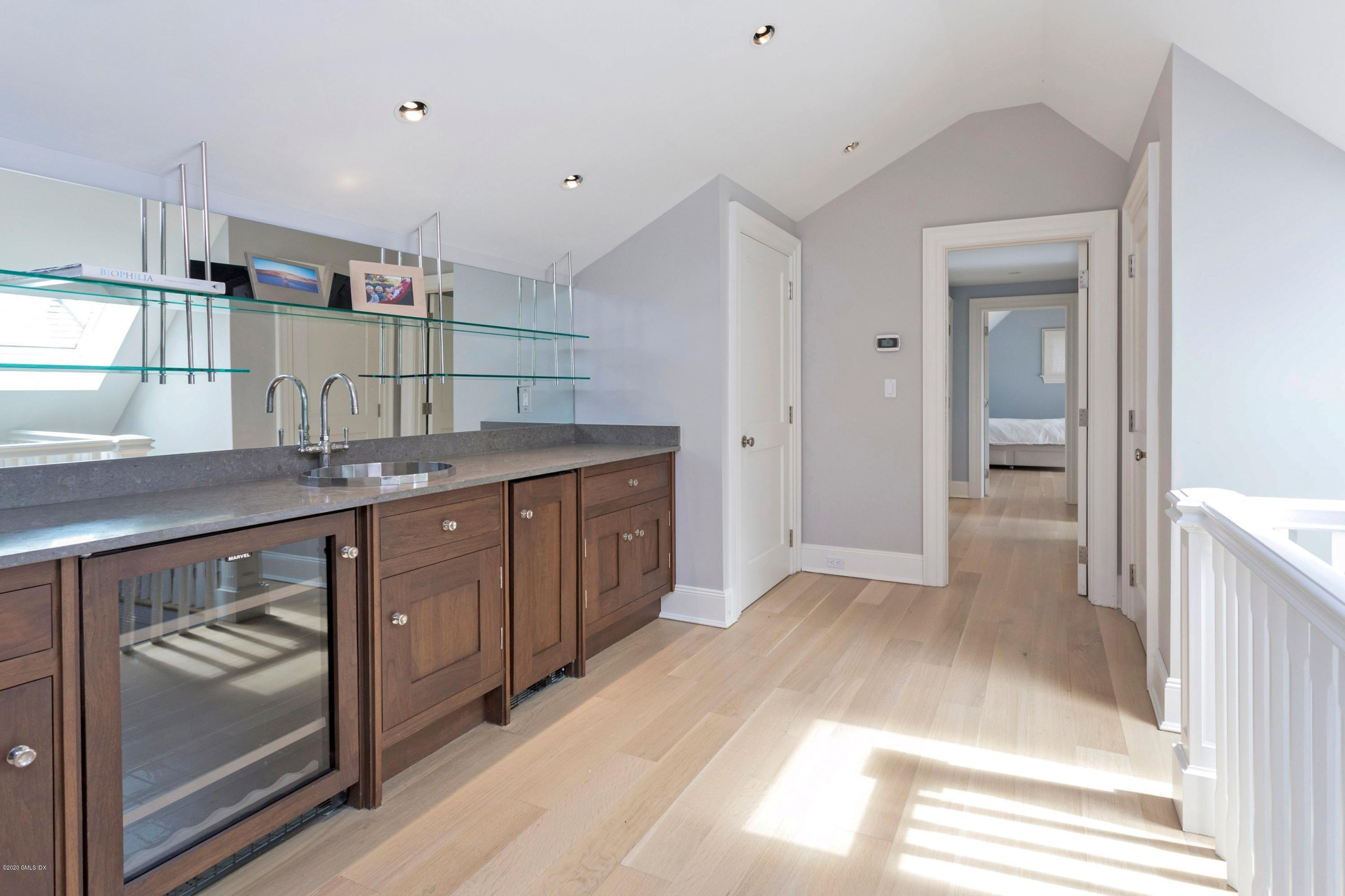 186 Shore Road Old Greenwich, CT 06870 - Photo 32 of 37 a kitchen with a sink and cabinets