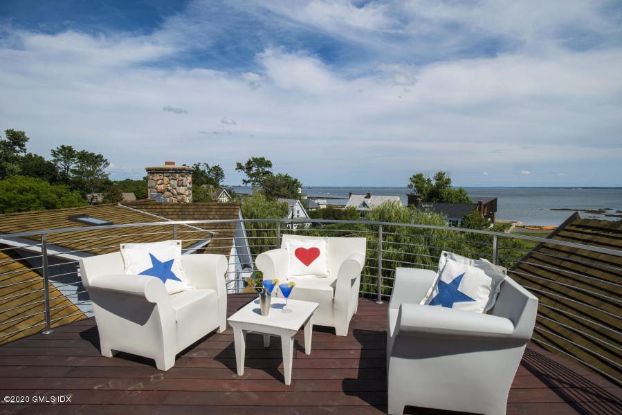 186 Shore Road Old Greenwich, CT 06870 - Photo 37 of 37 an outdoor sitting area with furniture and wooden floor
