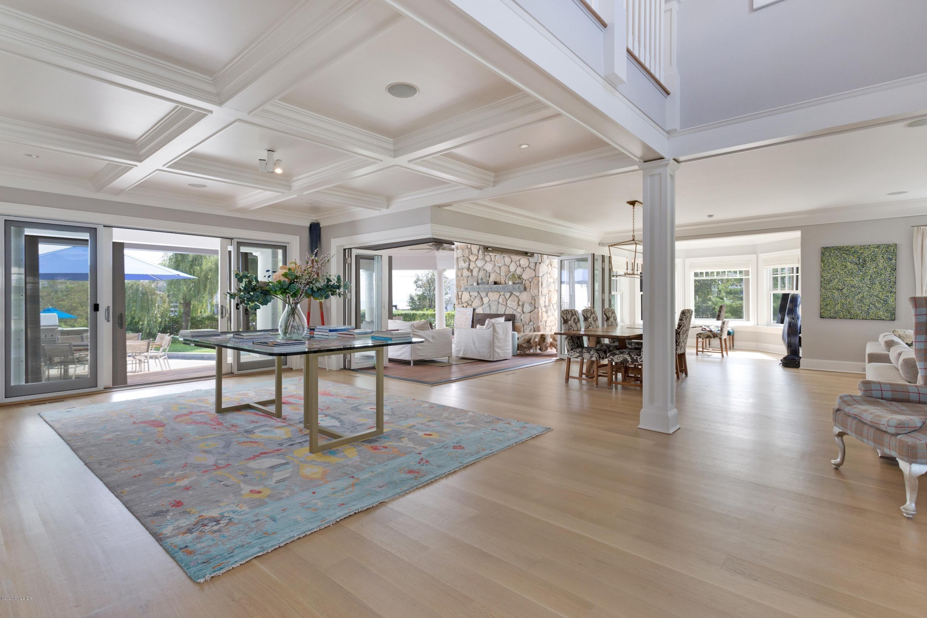 186 Shore Road Old Greenwich, CT 06870 - Photo 5 of 37 a dining room with wooden floor and glass door