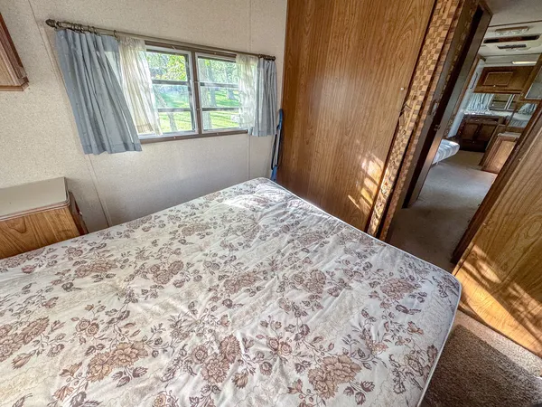 a bedroom with a bed and a window