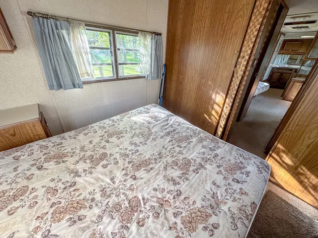 a bedroom with a bed and a window