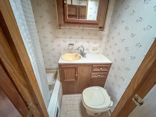 a bathroom with a sink a toilet and a mirror