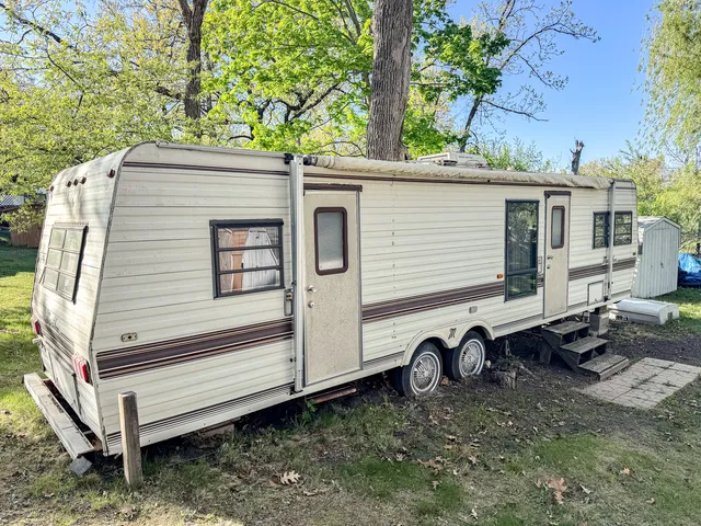 a view of a small house with a yard