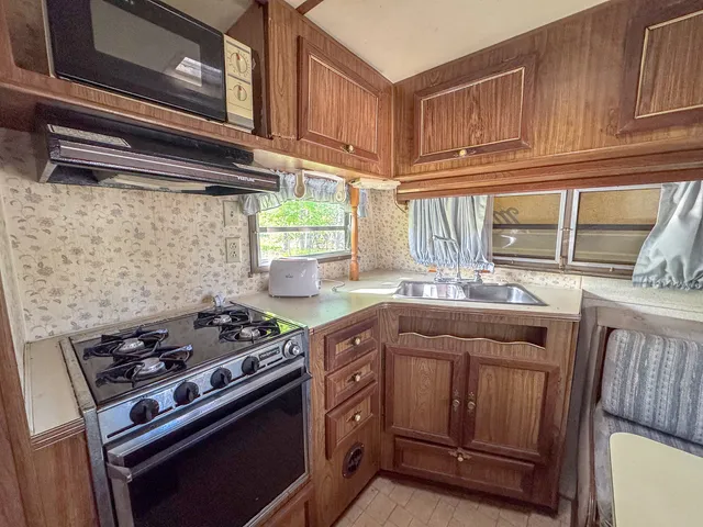a kitchen with stainless steel appliances granite countertop a stove and a sink