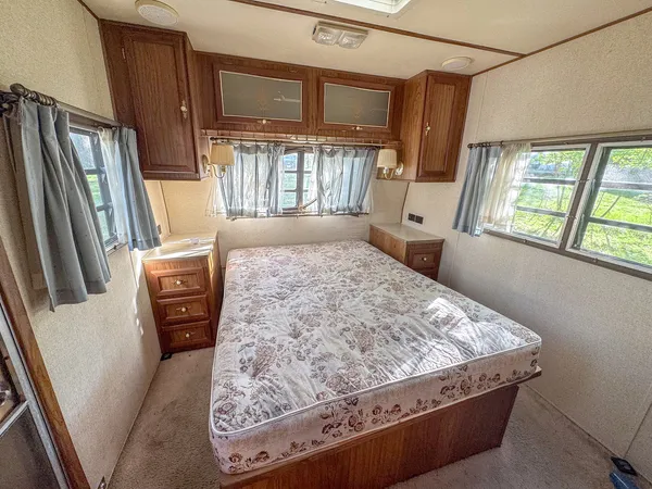 a bed sitting in a bedroom next to a window