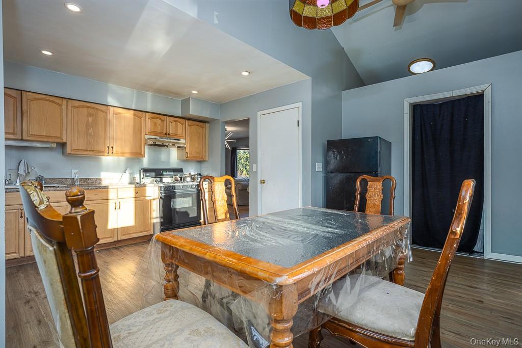 19 James Road Monroe, NY 10950 - Photo 18 of 22 a kitchen with stainless steel appliances granite countertop a stove refrigerator a sink dishwasher a dining table and chairs with wooden floor
