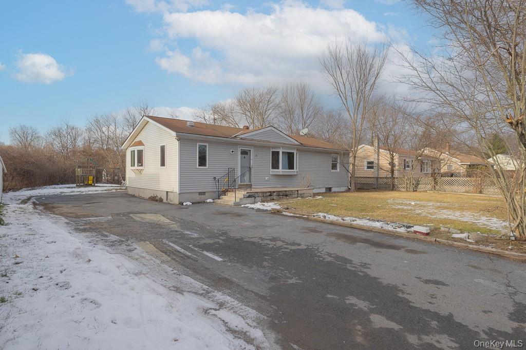 19 James Road Monroe, NY 10950 - Photo 3 of 22 a view of white house with a big yard and large trees