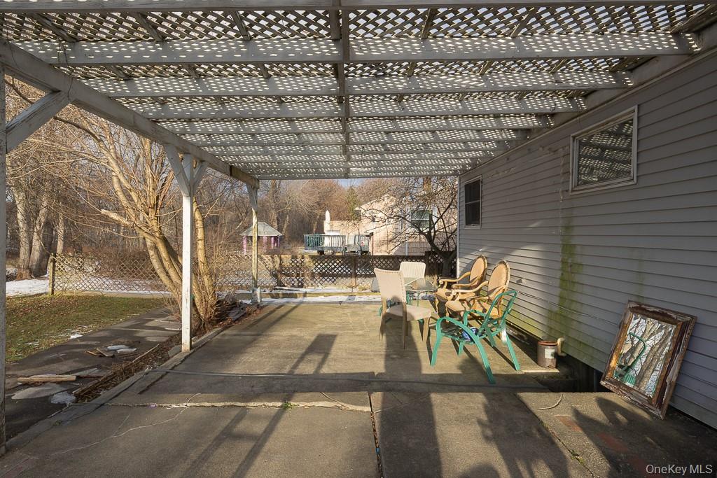 19 James Road Monroe, NY 10950 - Photo 7 of 22 a view of a patio with table and chairs with wooden floor