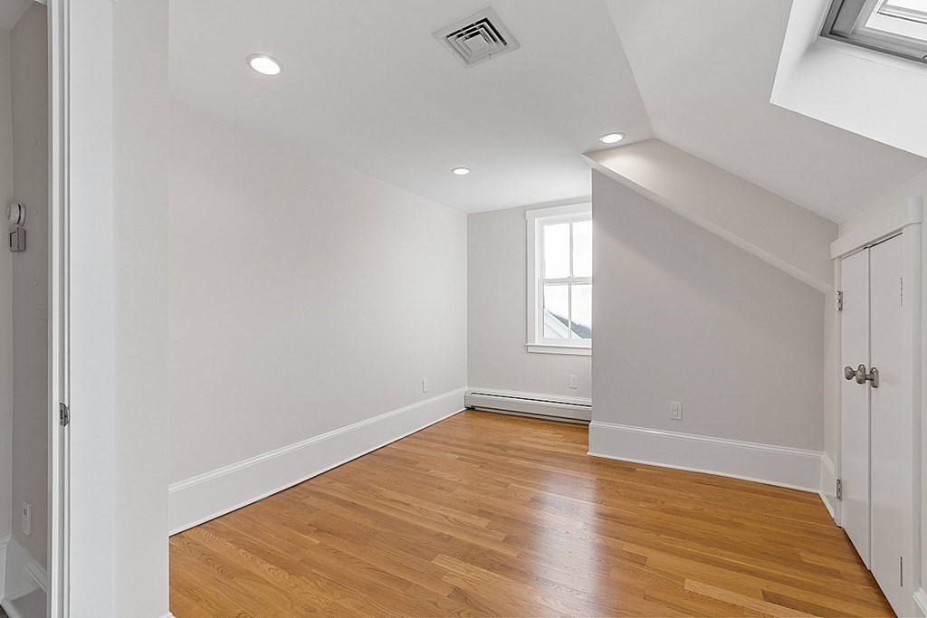 29 Central Street, Unit 2 Manchester, MA 01944 - Photo 14 of 22 an empty room with wooden floor and windows