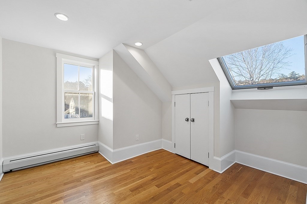 29 Central Street, Unit 2 Manchester, MA 01944 - Photo 15 of 22 a view of an empty room with window and wooden floor