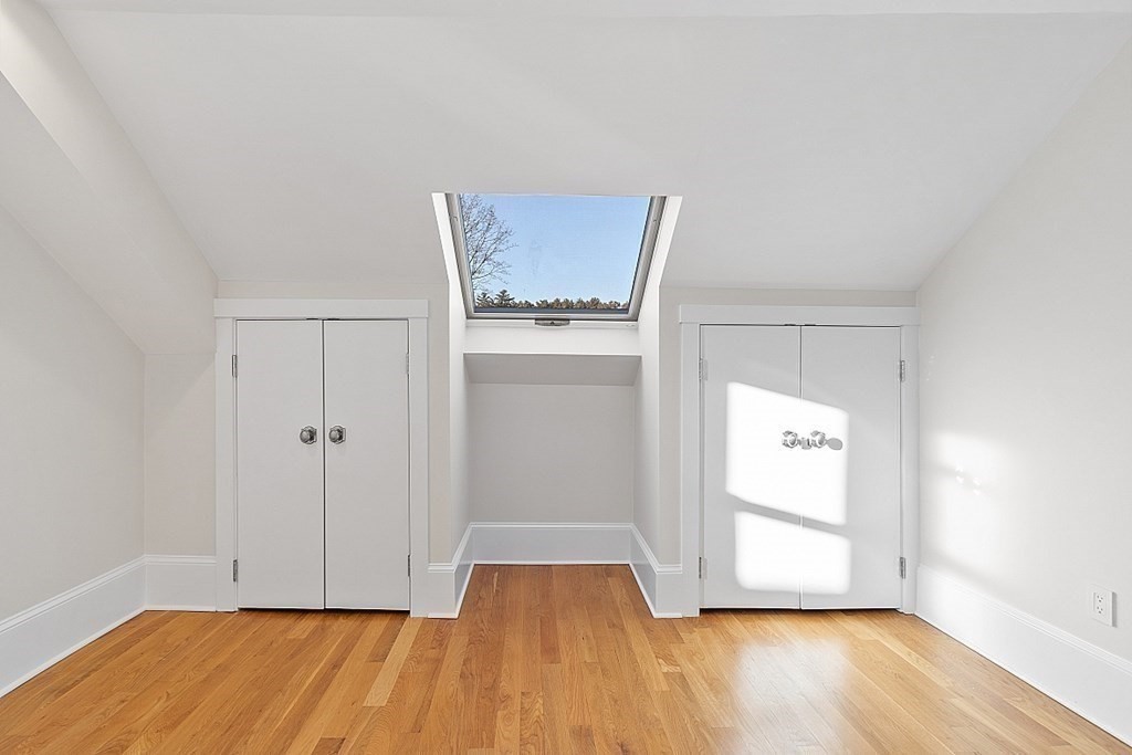 29 Central Street, Unit 2 Manchester, MA 01944 - Photo 16 of 22 an empty room with wooden floor and cabinet