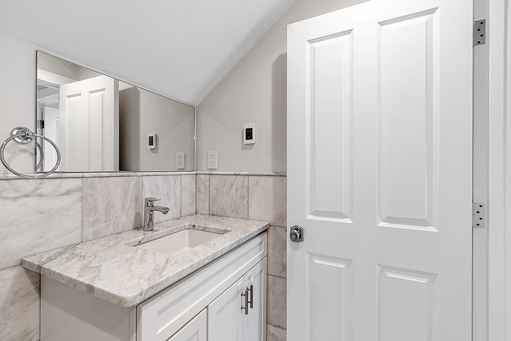29 Central Street, Unit 2 Manchester, MA 01944 - Photo 18 of 22 a bathroom with a sink and a mirror