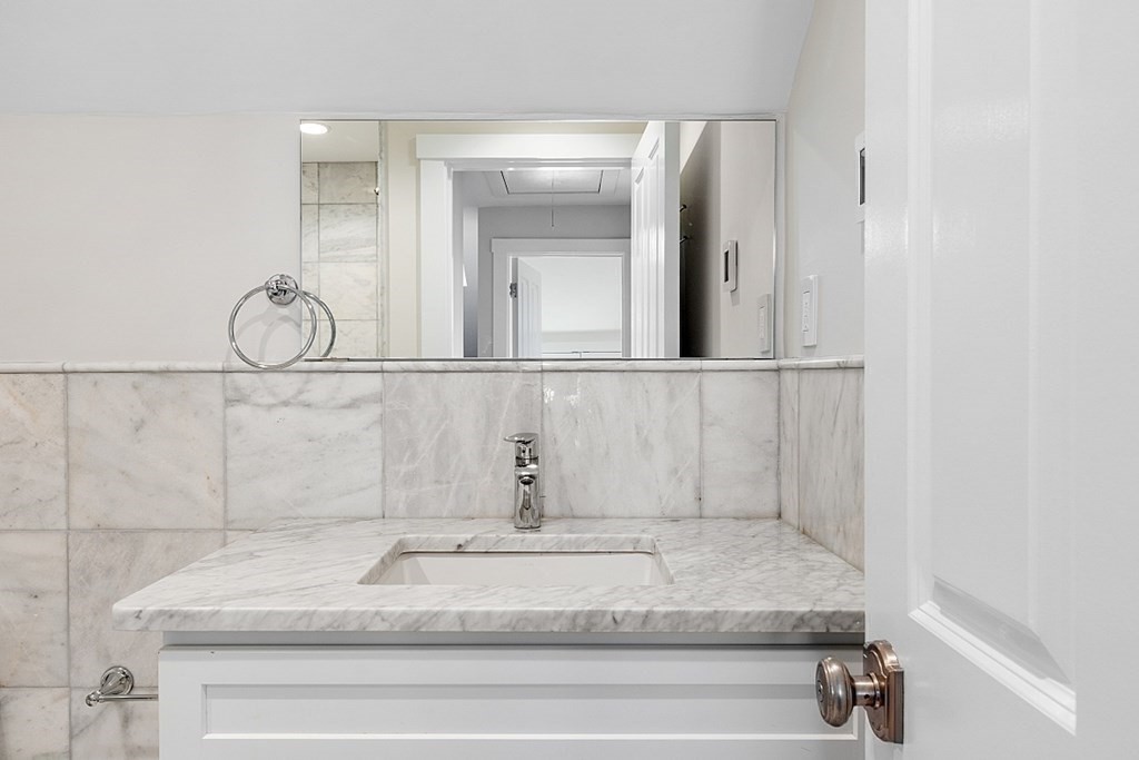 29 Central Street, Unit 2 Manchester, MA 01944 - Photo 19 of 22 a bathroom with a sink and mirror