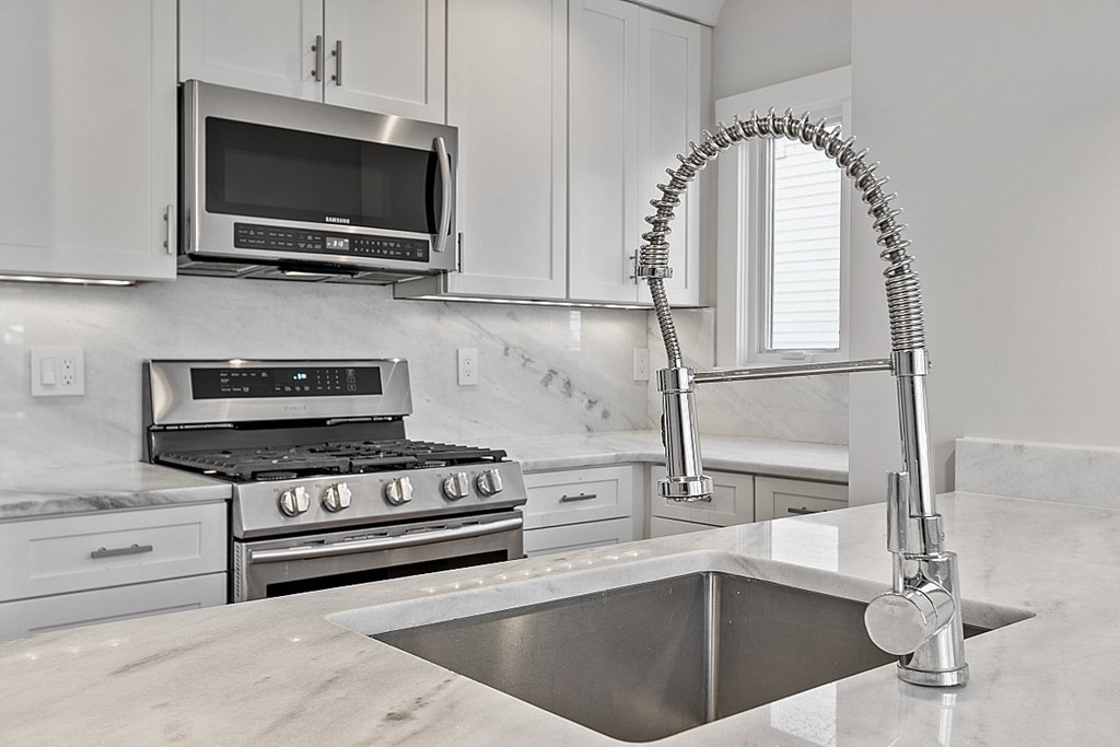 29 Central Street, Unit 2 Manchester, MA 01944 - Photo 9 of 22 a kitchen with a sink a stove and microwave