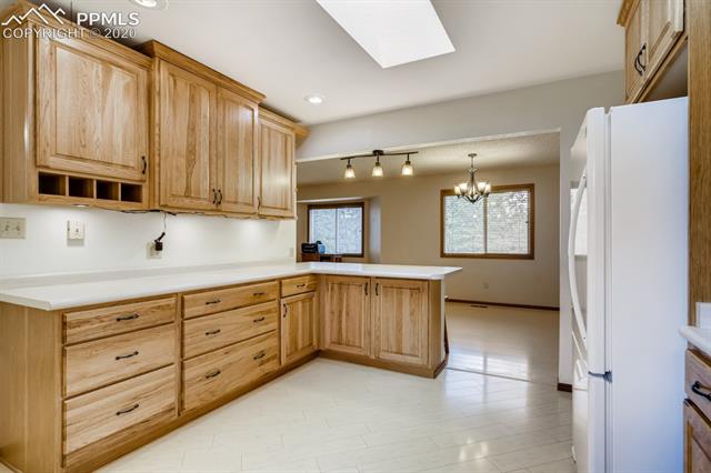 7575 Tobin Road Colorado Springs, CO 80908 - Photo 5 of 27 Open kitchen with beautiful new cabinets