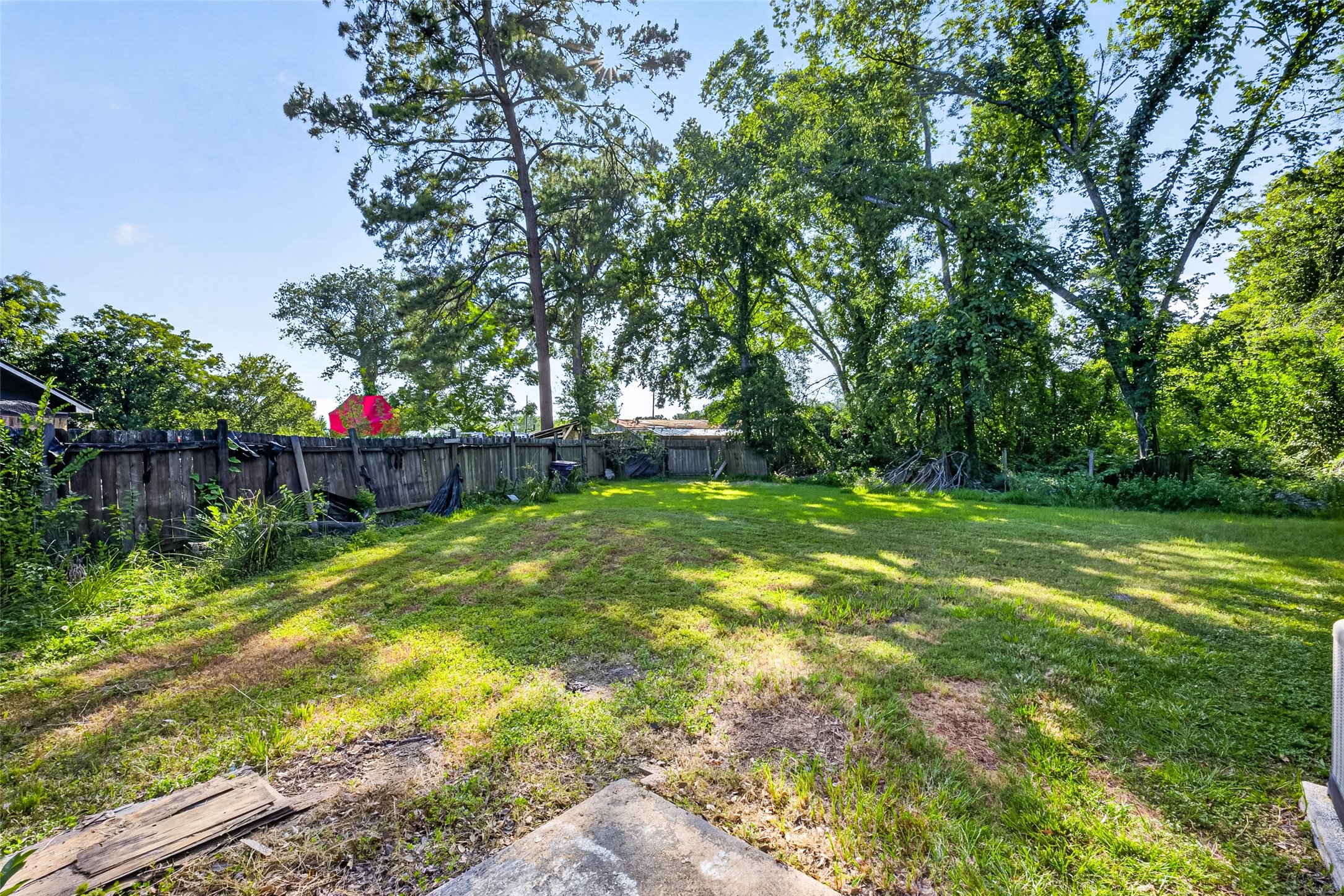 22926 Millgate Drive Spring, TX 77373 - Photo 34 of 34 Spacious backyard with lush greenery and mature trees, offering ample privacy and a serene atmosphere. Ideal for outdoor activities and relaxation.