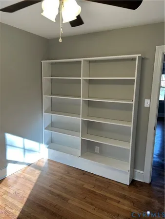 a room with walk in closet and wooden floor