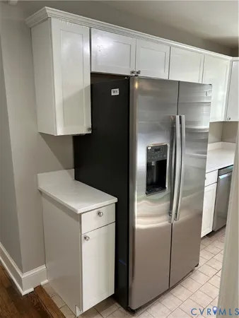 a kitchen with a refrigerator and a sink