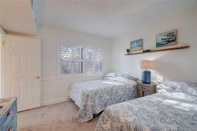 a bedroom with two beds and a window