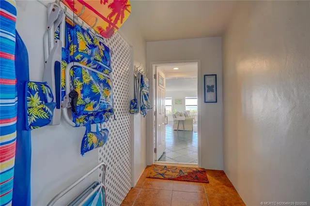 a walk in closet with wooden floor
