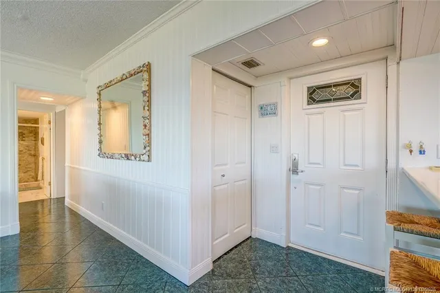 a view of a hallway with wooden floor and closet