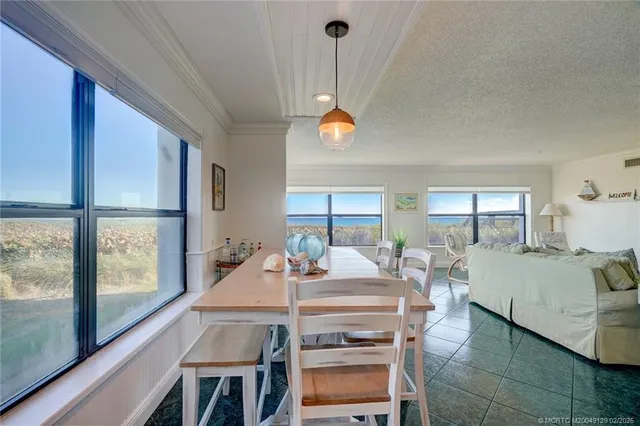 a view of a dining room with furniture window and outside view