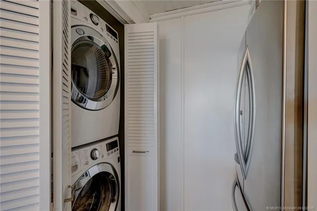 a view of a storage and utility room with washer and dryer