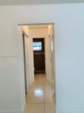 a view of a hallway to rooms