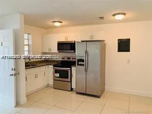 a kitchen with stainless steel appliances a refrigerator sink and microwave