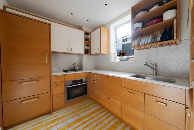 a kitchen with stainless steel appliances and cabinets