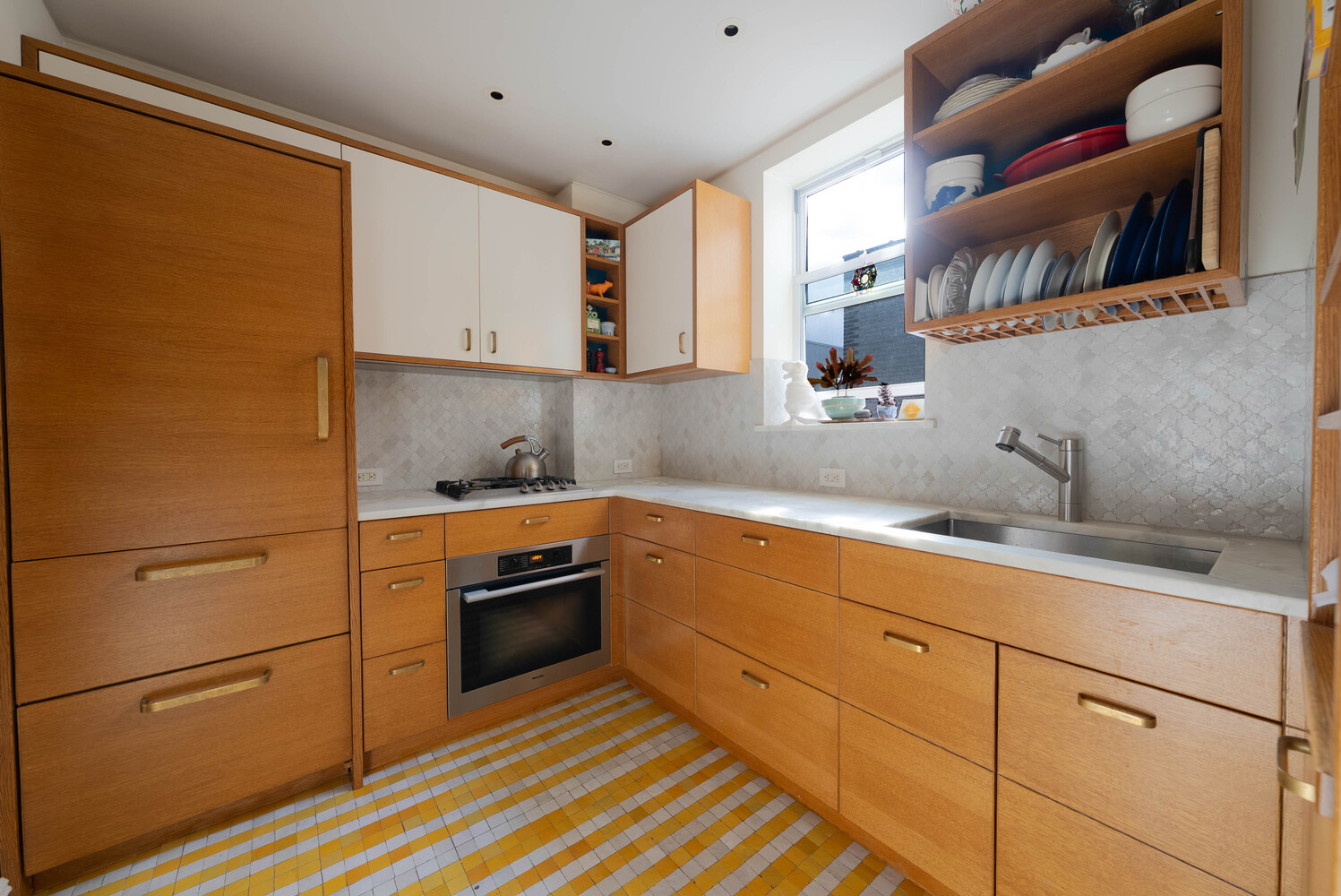 210 West 19th Street, Unit 6D Manhattan, NY 10011 - Photo 1 of 12 a kitchen with stainless steel appliances and cabinets