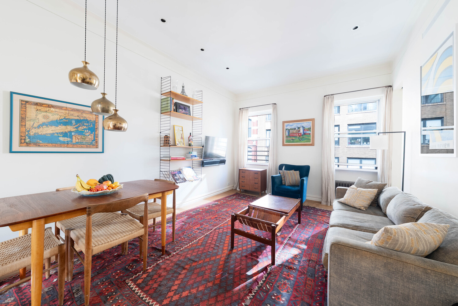 210 West 19th Street, Unit 6D Manhattan, NY 10011 - Photo 11 of 12 a living room with furniture a rug and a bookshelf