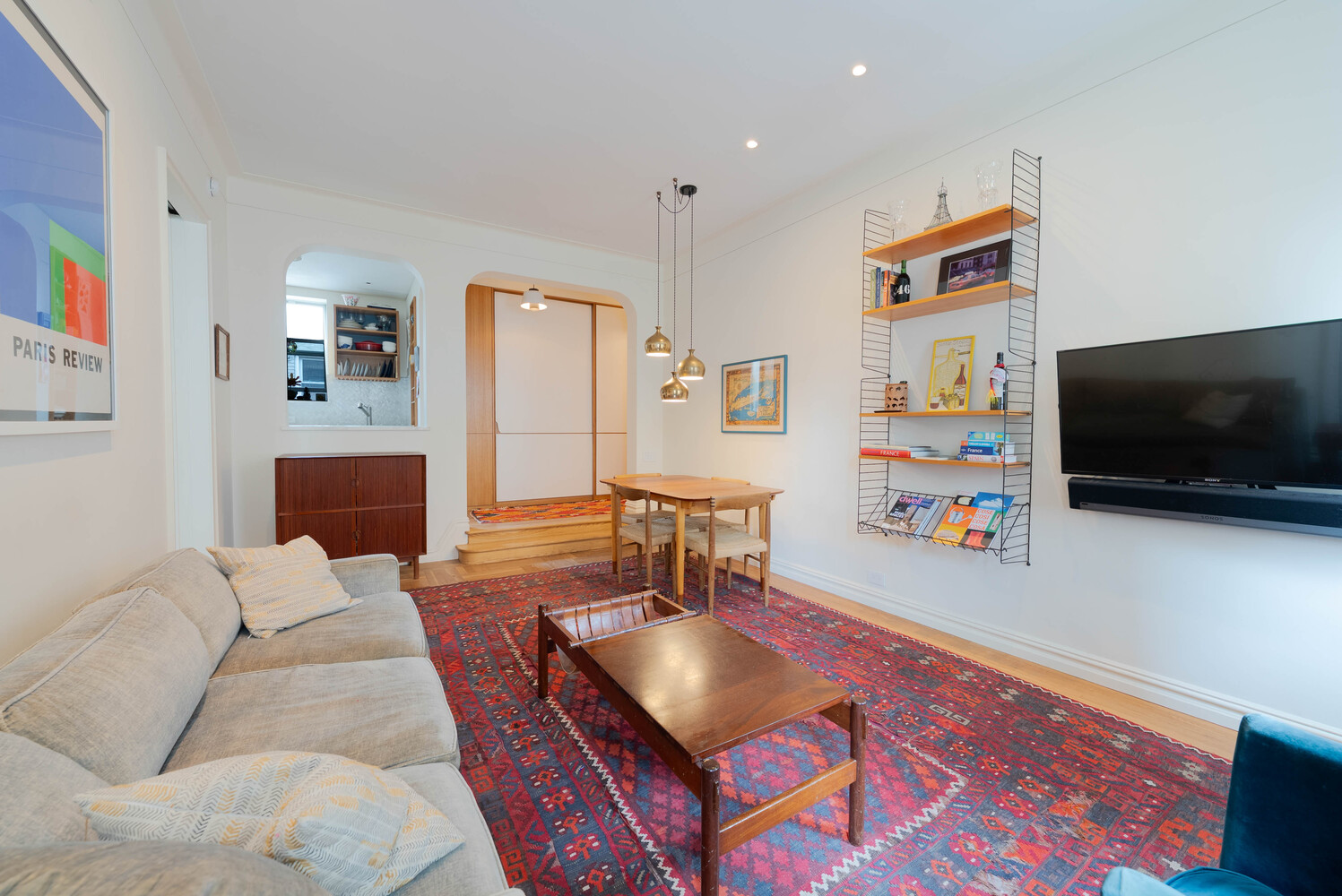 210 West 19th Street, Unit 6D Manhattan, NY 10011 - Photo 12 of 12 a living room with furniture and a flat screen tv