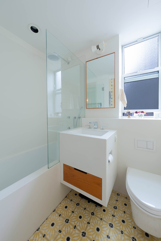 210 West 19th Street, Unit 6D Manhattan, NY 10011 - Photo 7 of 12 a bathroom with a sink a toilet and mirror