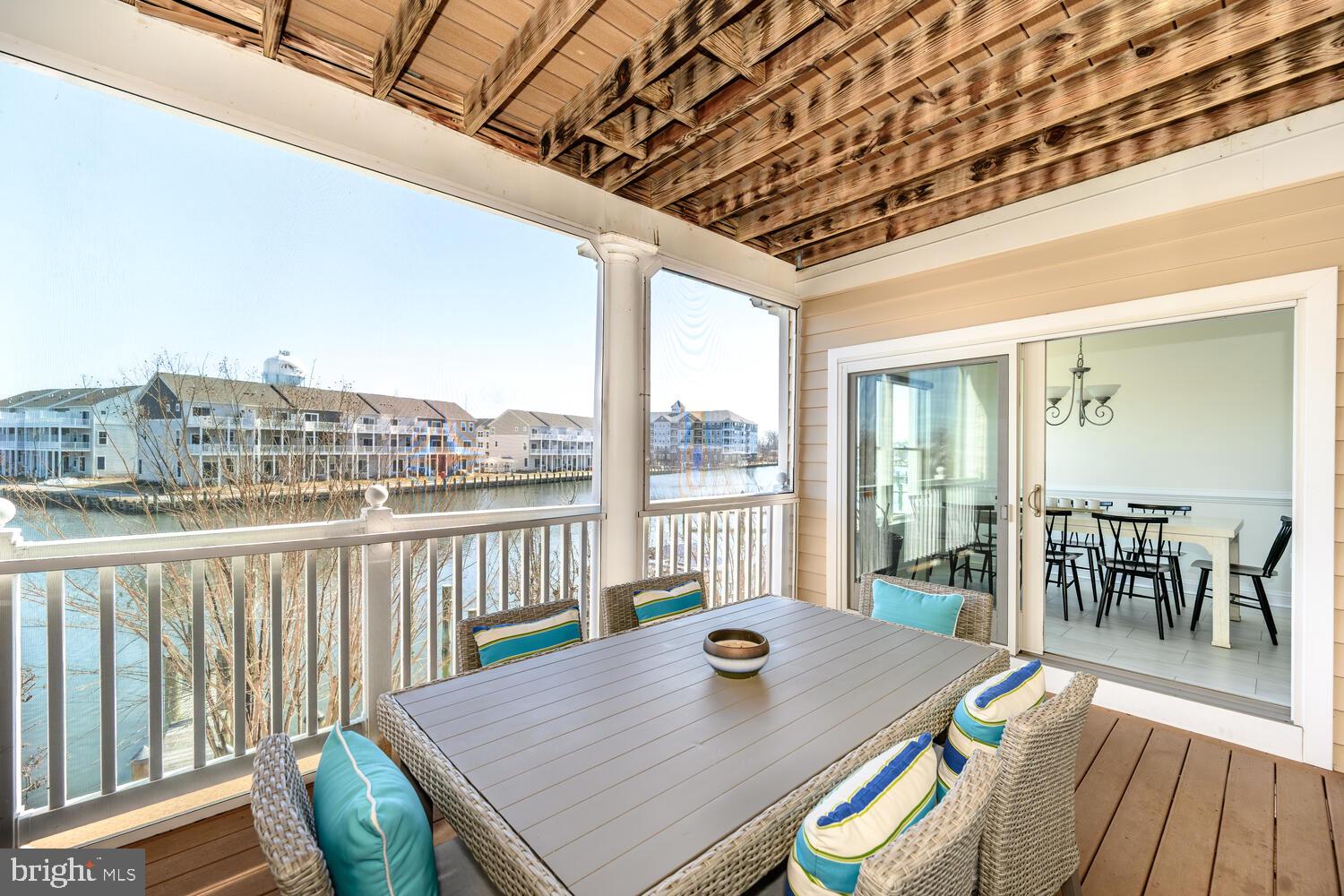 202 Muir Street, Unit 202 Cambridge, MD 21613 - Photo 12 of 54 a view of a dining room with furniture window and wooden floor