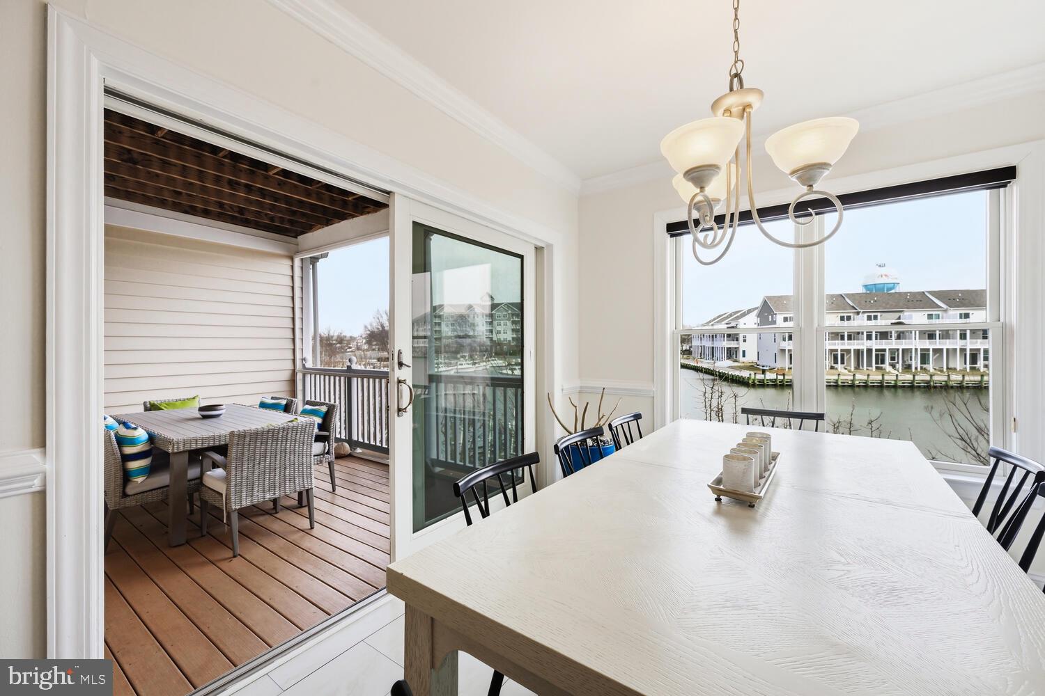 202 Muir Street, Unit 202 Cambridge, MD 21613 - Photo 14 of 54 a view of a dining room with furniture window and outside view