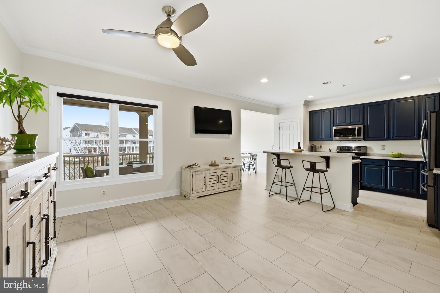 202 Muir Street, Unit 202 Cambridge, MD 21613 - Photo 16 of 54 a living room with stainless steel appliances kitchen island granite countertop furniture and a view of kitchen