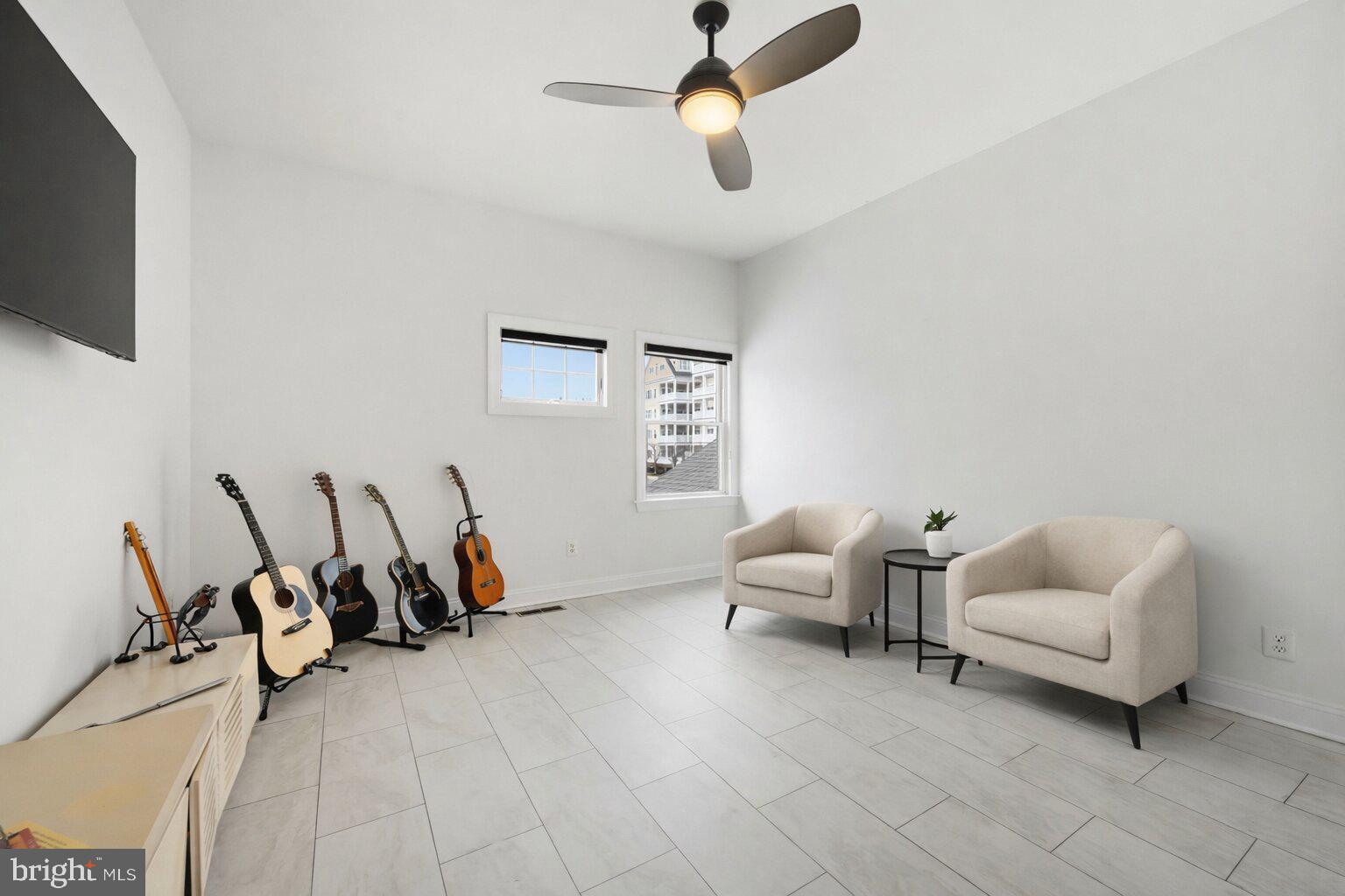 202 Muir Street, Unit 202 Cambridge, MD 21613 - Photo 20 of 54 a living room with furniture and a flat screen tv