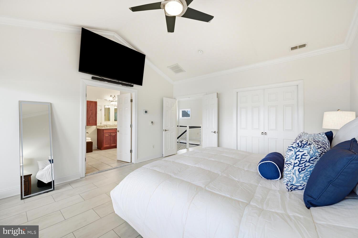 202 Muir Street, Unit 202 Cambridge, MD 21613 - Photo 26 of 54 a bedroom with a bed and a flat screen tv